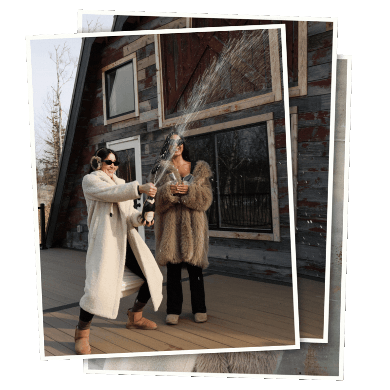 Two people in coats celebrate on a deck outside a barn-style building as one sprays a bottle, shown in a layered photo collage. Borealis Bison Barns | Palmer, AK